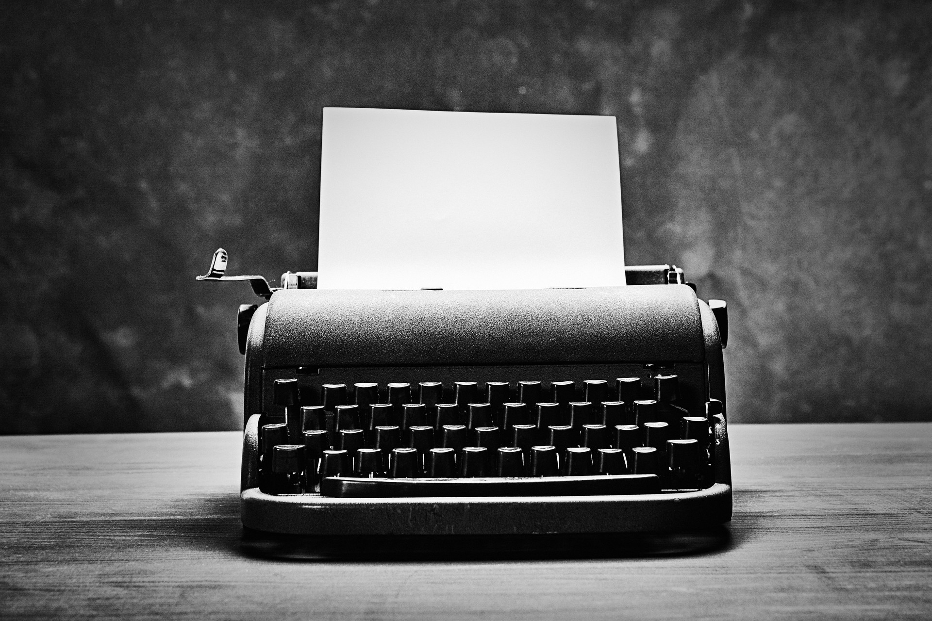 Antique typewriter from the mid-20th century with a blank page of paper ready for a novel