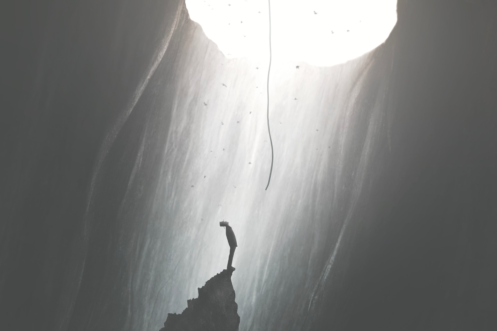 man finding a way to get out of darkness, help from the sky, surreal concept